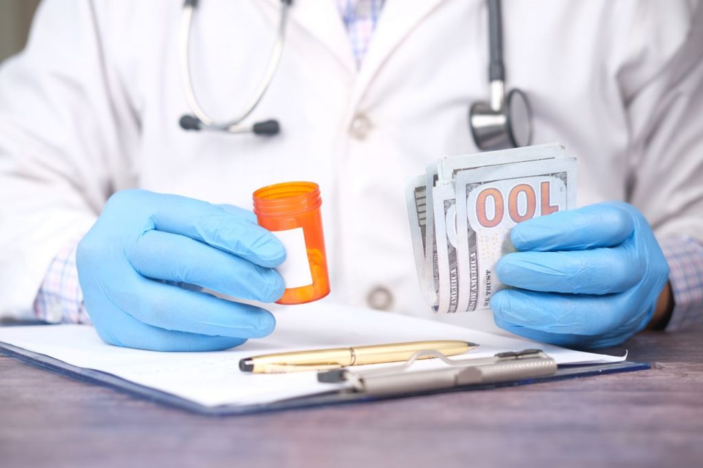 Medical doctor holding prescription pill bottle and stack of cash, representing a BPC 725(b) excessive prescribing and illegal prescribing investigation.