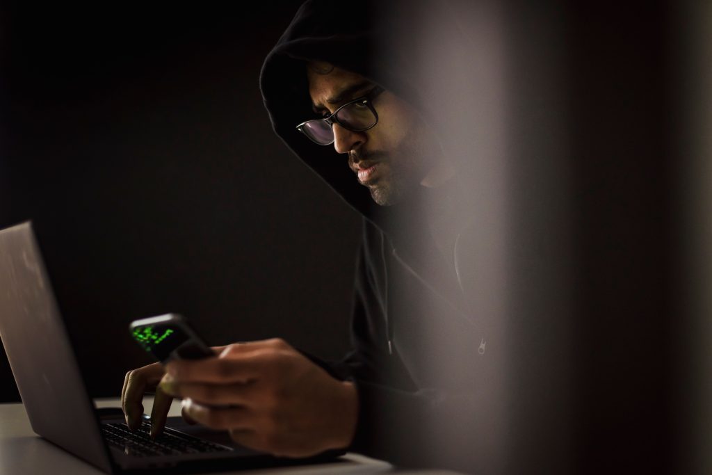Person reading threatening messages on a phone in a California cyber harassment case